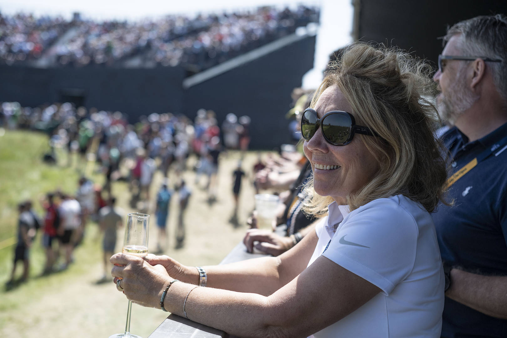 Woman enjoying view of golf from hospitality